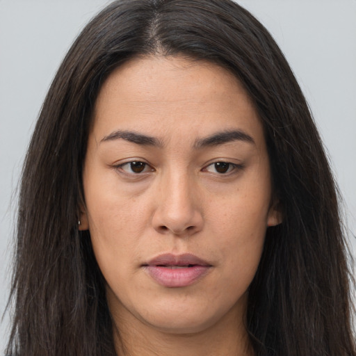 Joyful asian young-adult female with long  brown hair and brown eyes