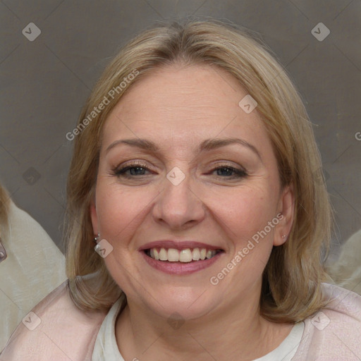 Joyful white adult female with medium  brown hair and blue eyes