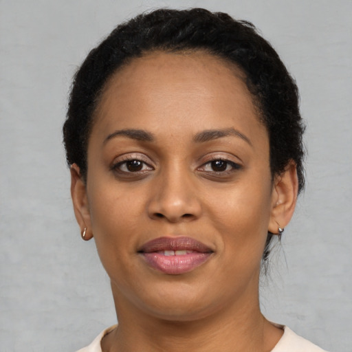 Joyful latino young-adult female with short  black hair and brown eyes