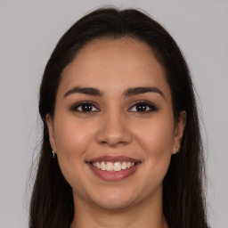 Joyful white young-adult female with long  brown hair and brown eyes