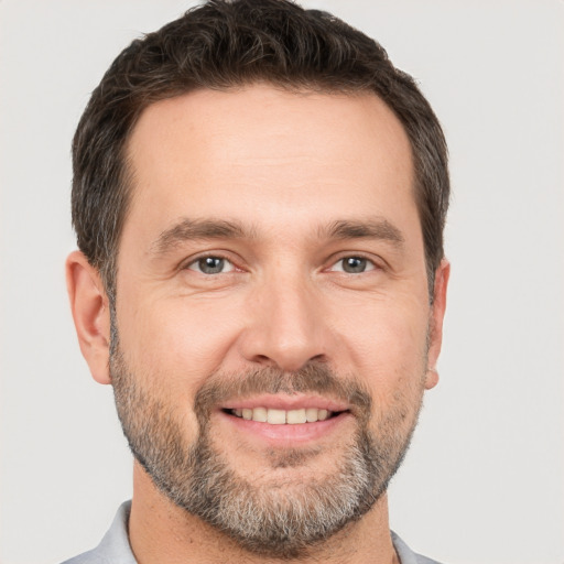 Joyful white adult male with short  brown hair and brown eyes