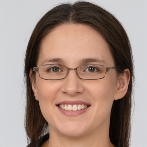 Joyful white adult female with long  brown hair and grey eyes