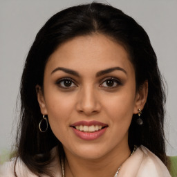 Joyful latino young-adult female with long  brown hair and brown eyes