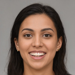 Joyful latino young-adult female with long  brown hair and brown eyes