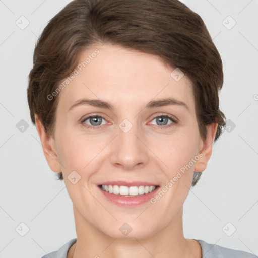 Joyful white young-adult female with short  brown hair and grey eyes