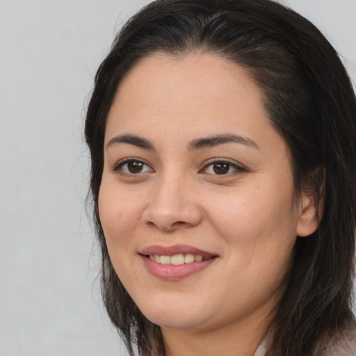 Joyful asian young-adult female with long  brown hair and brown eyes