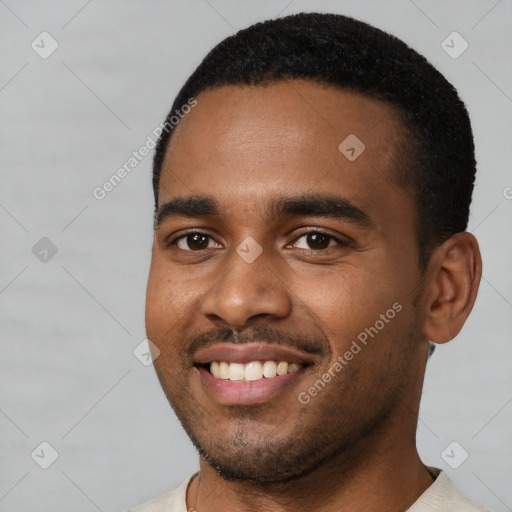 Joyful black young-adult male with short  black hair and brown eyes