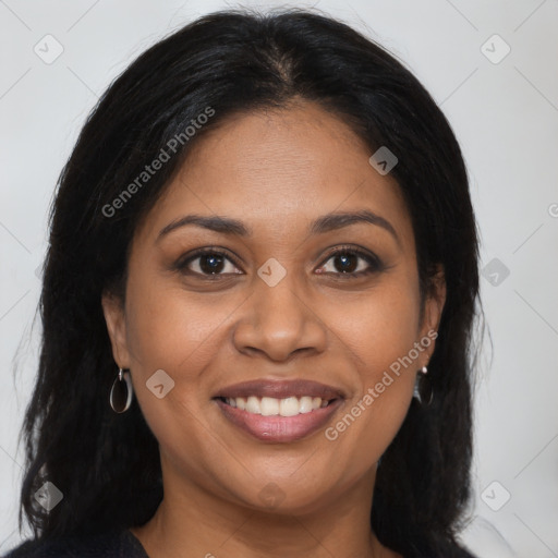 Joyful black young-adult female with long  brown hair and brown eyes