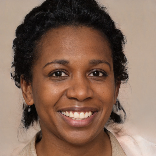 Joyful black young-adult female with medium  black hair and brown eyes