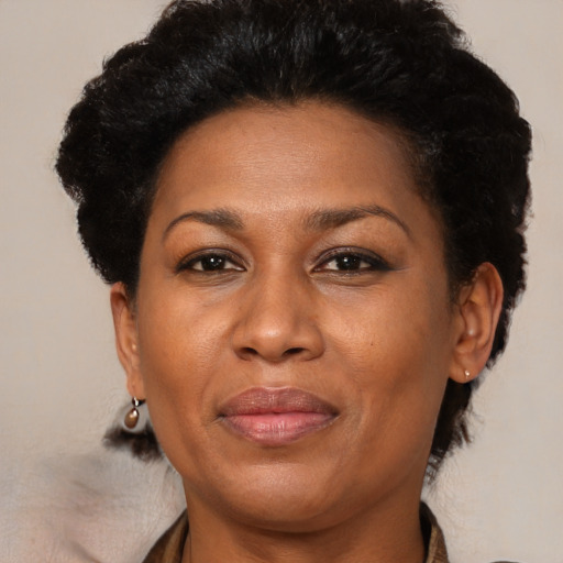 Joyful black adult female with short  brown hair and brown eyes