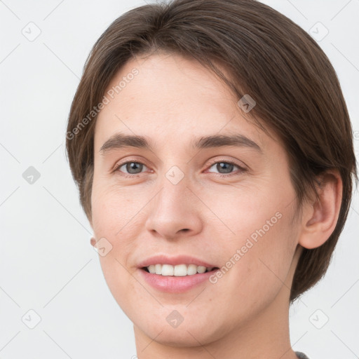 Joyful white young-adult female with short  brown hair and grey eyes