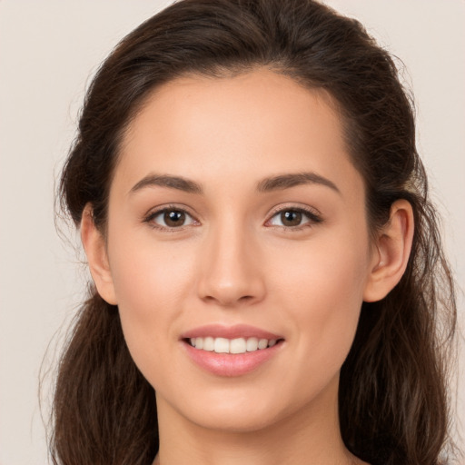 Joyful white young-adult female with long  brown hair and brown eyes