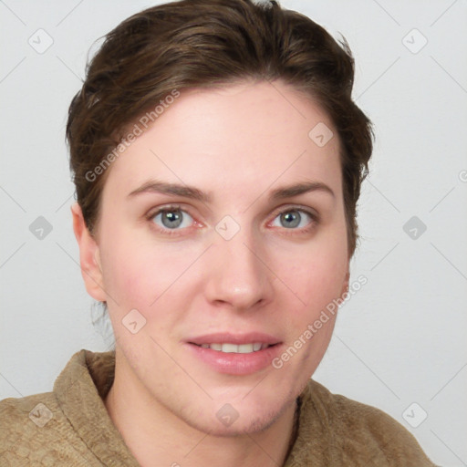 Joyful white young-adult female with short  brown hair and blue eyes