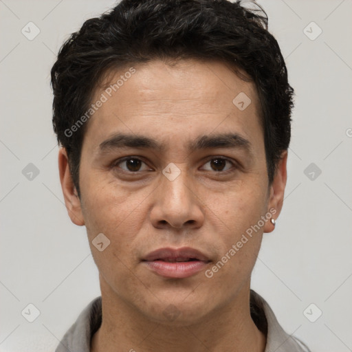 Joyful white adult male with short  black hair and brown eyes