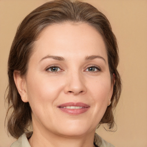 Joyful white adult female with medium  brown hair and brown eyes