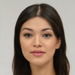 Joyful asian young-adult female with long  brown hair and brown eyes