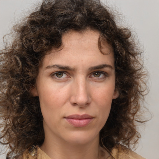 Joyful white young-adult female with medium  brown hair and green eyes