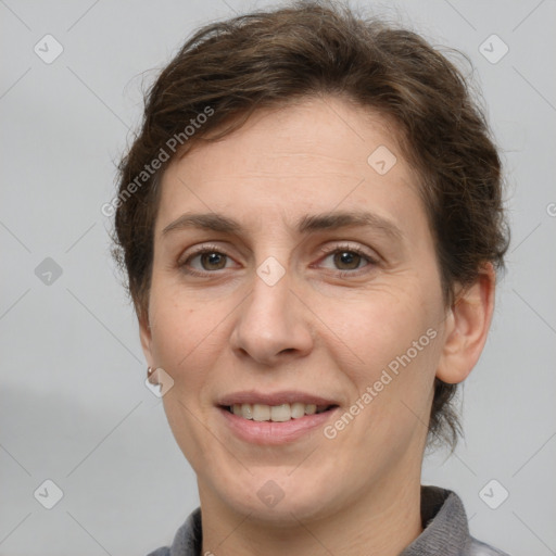 Joyful white adult female with short  brown hair and grey eyes