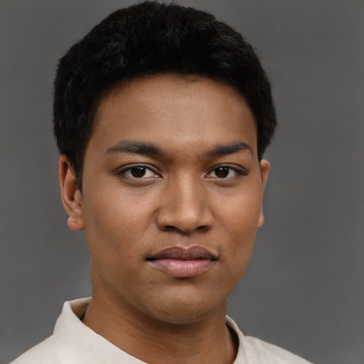 Joyful black young-adult male with short  black hair and brown eyes