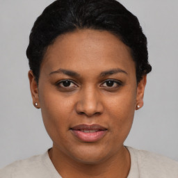 Joyful latino young-adult female with short  black hair and brown eyes