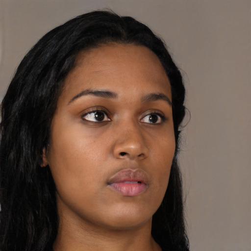 Neutral black young-adult female with long  brown hair and brown eyes