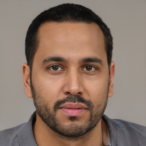 Neutral latino young-adult male with short  brown hair and brown eyes