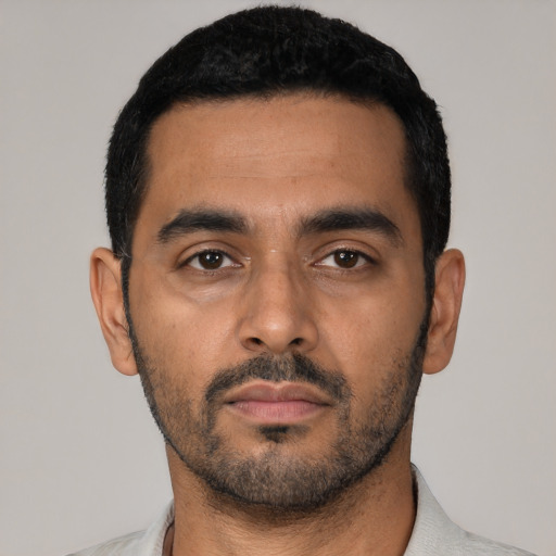 Neutral latino young-adult male with short  black hair and brown eyes