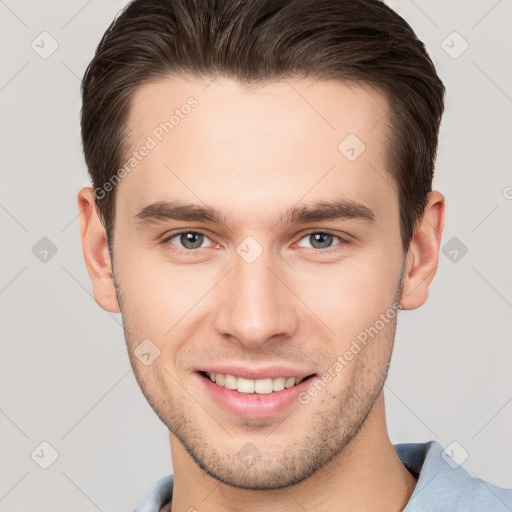 Joyful white young-adult male with short  brown hair and brown eyes