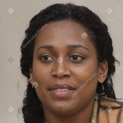 Joyful black young-adult female with long  brown hair and brown eyes