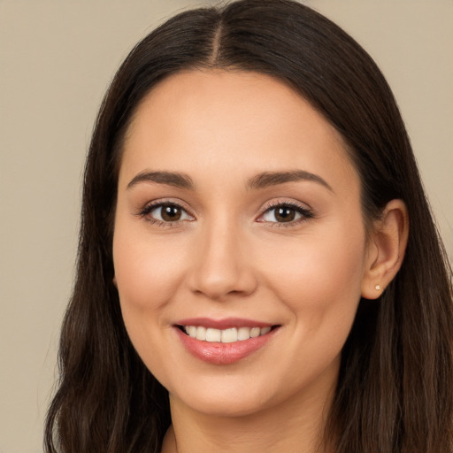 Joyful white young-adult female with long  brown hair and brown eyes