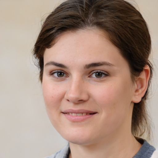 Joyful white young-adult female with medium  brown hair and brown eyes