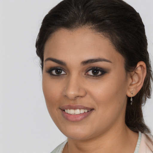 Joyful latino young-adult female with medium  brown hair and brown eyes