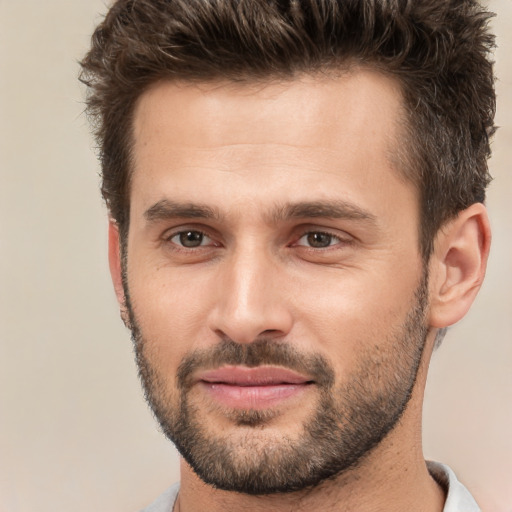 Joyful white young-adult male with short  brown hair and brown eyes