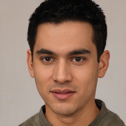 Joyful white young-adult male with short  black hair and brown eyes