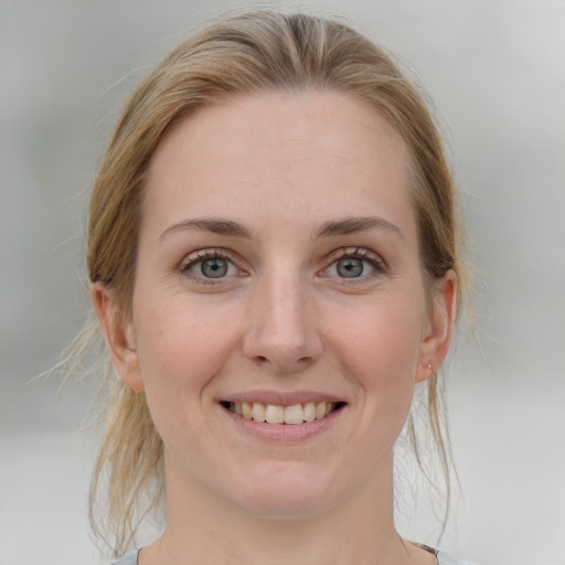 Joyful white young-adult female with medium  brown hair and blue eyes