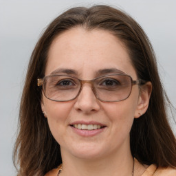 Joyful white adult female with long  brown hair and grey eyes