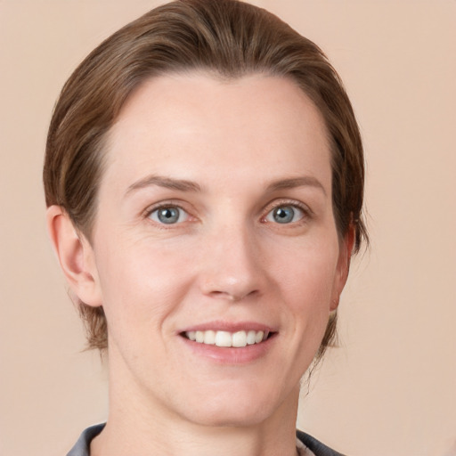 Joyful white young-adult female with short  brown hair and grey eyes