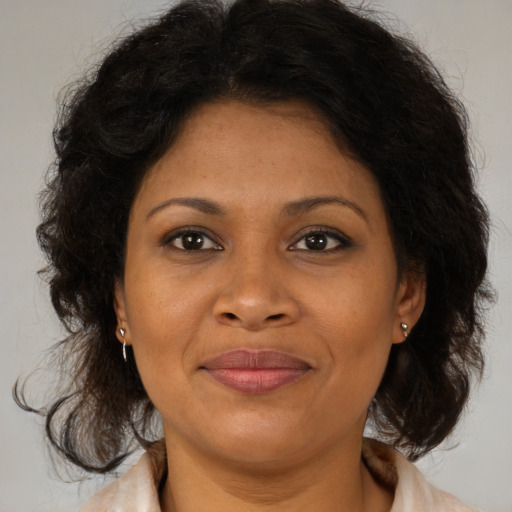 Joyful black adult female with medium  brown hair and brown eyes