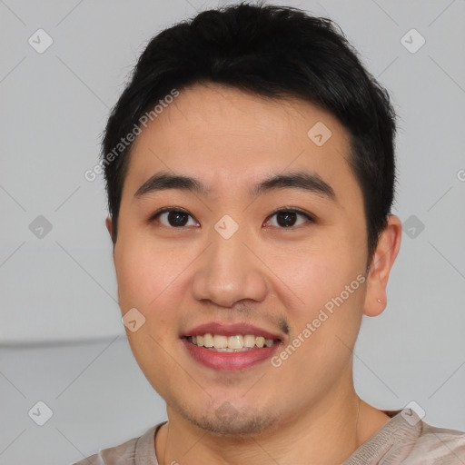 Joyful asian young-adult male with short  black hair and brown eyes