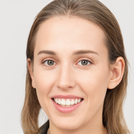 Joyful white young-adult female with long  brown hair and grey eyes