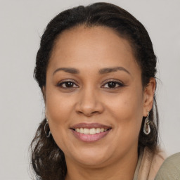 Joyful latino young-adult female with medium  brown hair and brown eyes