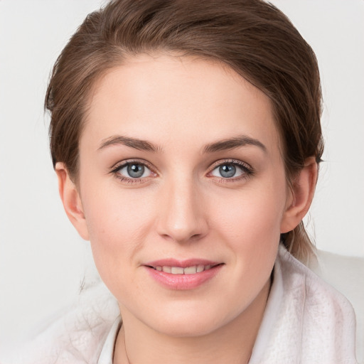 Joyful white young-adult female with medium  brown hair and blue eyes