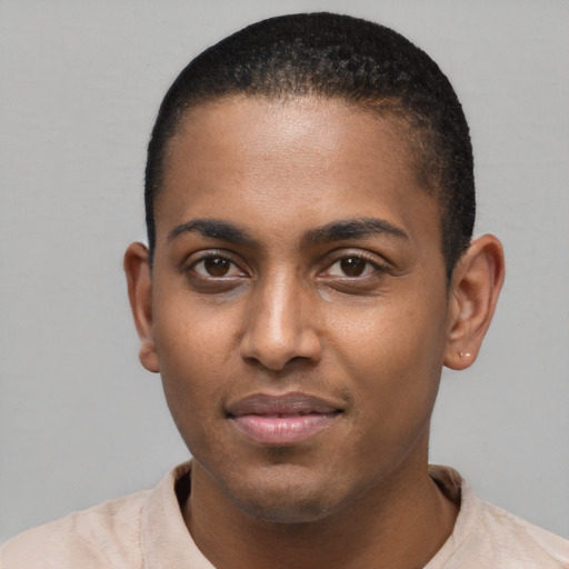 Joyful black young-adult male with short  brown hair and brown eyes