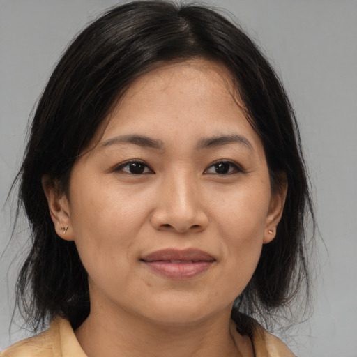 Joyful white adult female with medium  brown hair and brown eyes