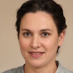 Joyful white adult female with medium  brown hair and brown eyes