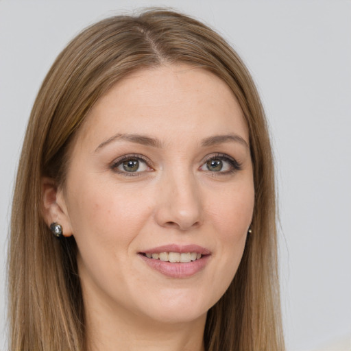 Joyful white young-adult female with long  brown hair and grey eyes