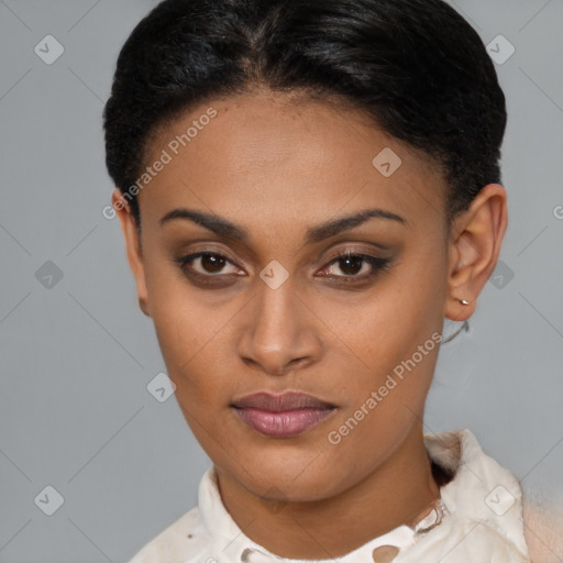 Joyful black young-adult female with short  brown hair and brown eyes