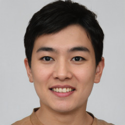 Joyful asian young-adult male with short  black hair and brown eyes