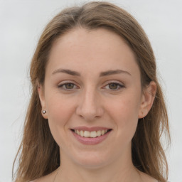 Joyful white young-adult female with long  brown hair and grey eyes