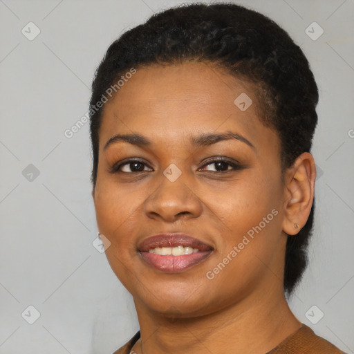 Joyful black young-adult female with short  black hair and brown eyes